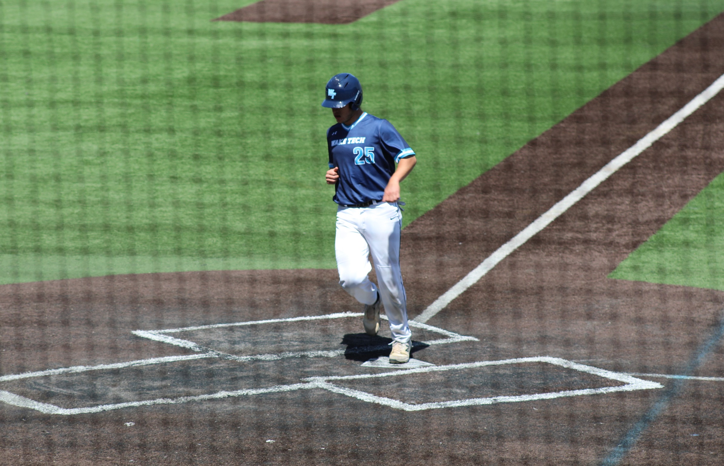 Tyler Sellers touches home plate in Sunday's 12-2 victory over Southwest Virginia. 