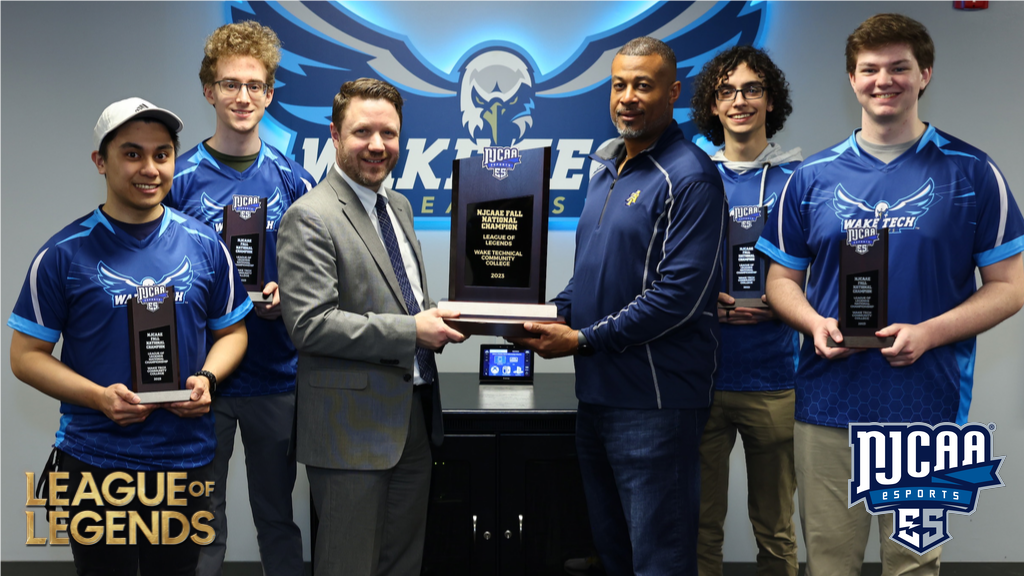 Members of the Wake Tech League of Legends team receive NJCAAE Fall Championship trophy from Vice President Brian Gann