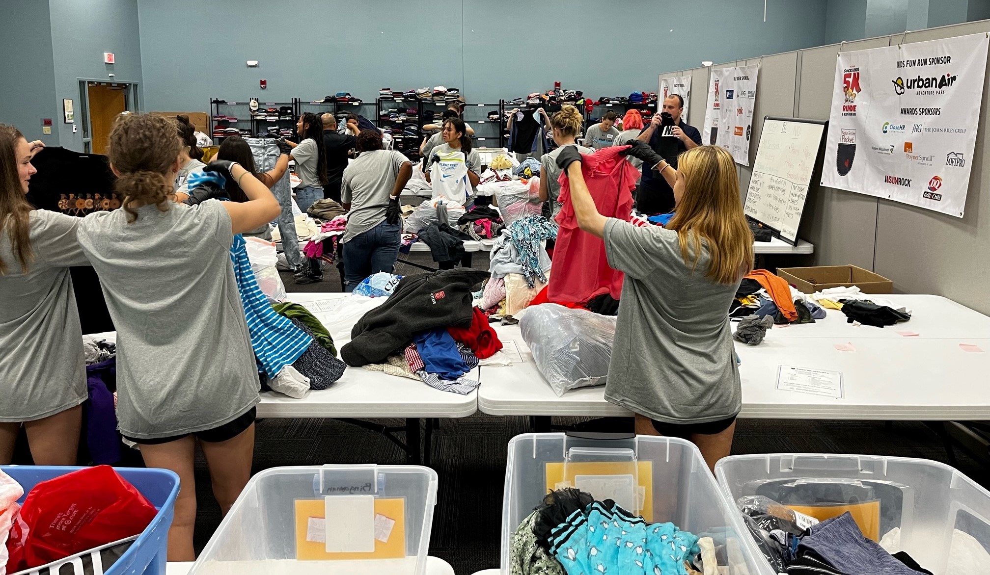 Wake Tech Women's Soccer Team sorts clothes at Note in the Pocket organization in Raleigh.